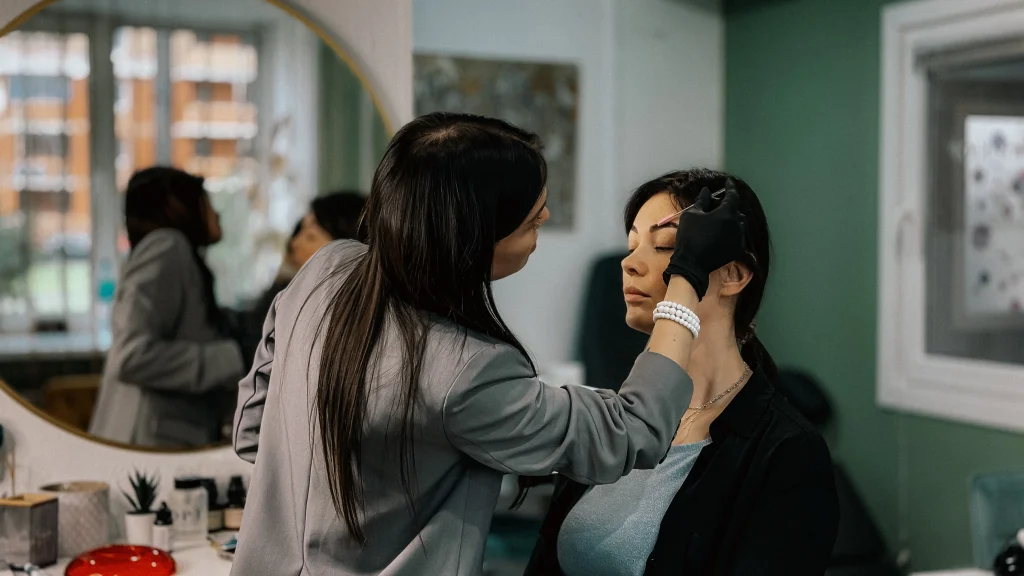 Hairdresser tends to woman's hair